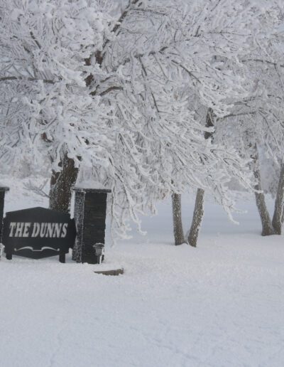 The dunns sign with a beautiful view of trees with frost